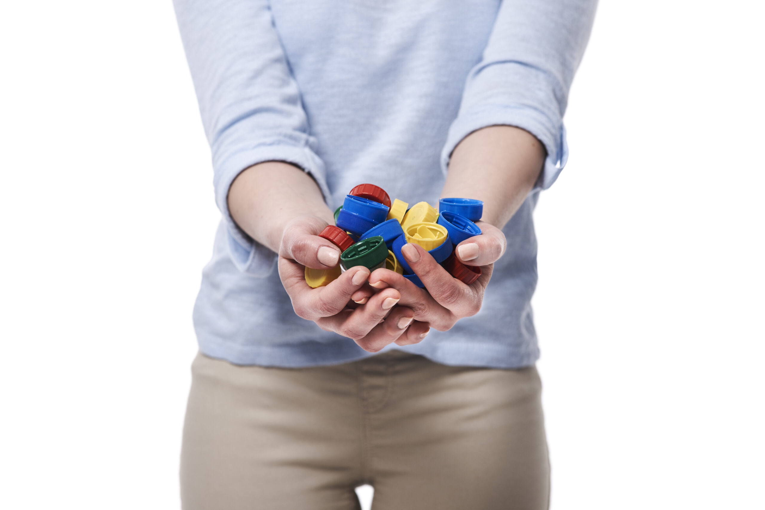 Close up of bottle caps in hands