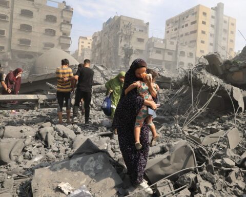 104617979 topshot palestinians evacuate the area following an israeli airstrike on the sousi m.jpg