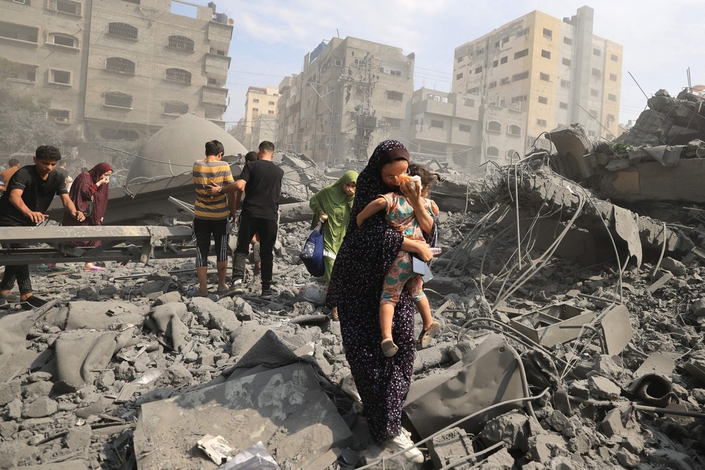 104617979 topshot palestinians evacuate the area following an israeli airstrike on the sousi m.jpg