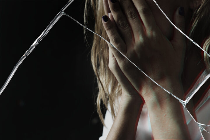 Depressed woman with cracked glass effect